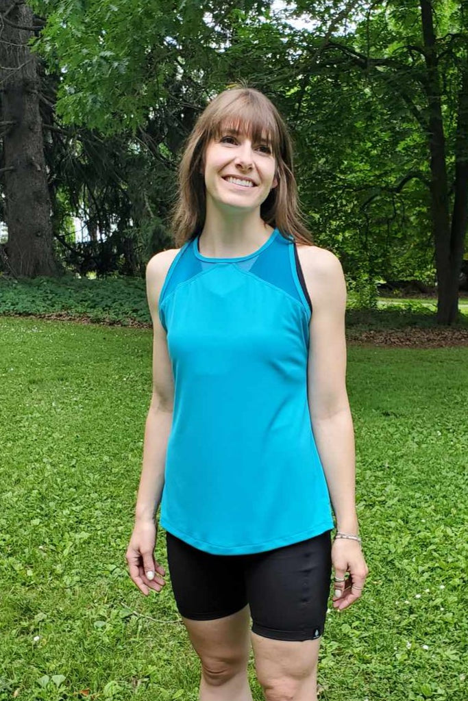 Blue tank top, breathable, fast-drying, wickable fabiric.  Mesh shoulder detail, long length.  Made in Canada